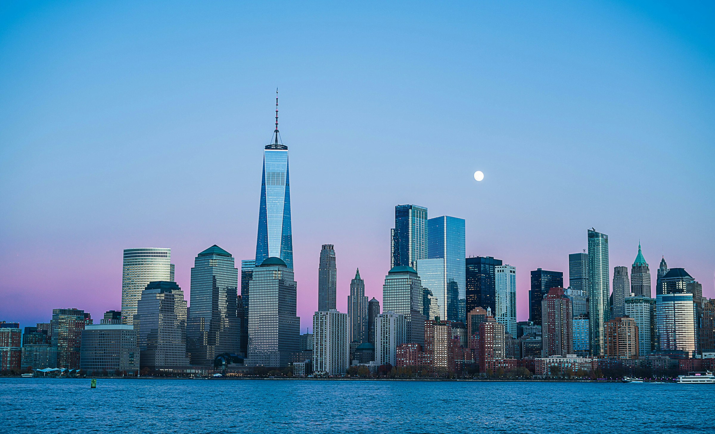 Lower Manhattan skyline at dusk, seen across the water